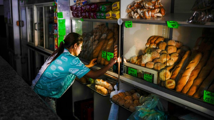 Eine Bäckereiverkäuferin während eines Blackouts in Venezuela (2024)